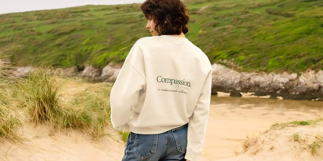 woman wearing Compassion Threads jumper outside